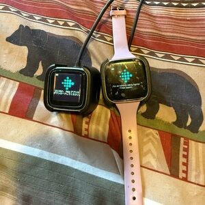 Pair of Fitbit Versa and Fitbit Versa 2, 2 chargers, 2 screen protectors, bands